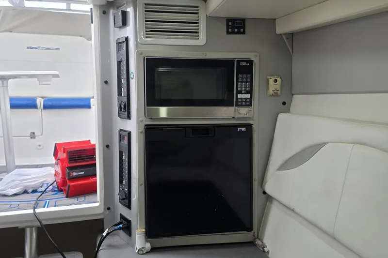  Yacht Photos Pics Interior of a 2016 Extreme Boats model featuring a microwave and mini fridge.