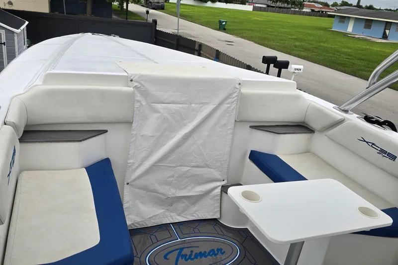  Yacht Photos Pics 2016 Extreme Boats interior with blue and white seating, table, and covered deck.
