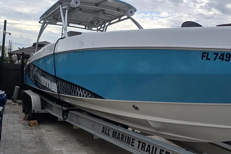  Yacht Photos Pics 2016 Extreme Boats model on trailer, blue and white design, parked outdoors.