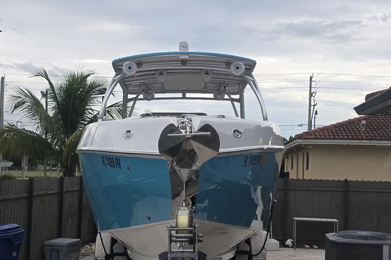  Yacht Photos Pics 2016 Extreme Boats model on trailer, parked in residential area with palm trees.