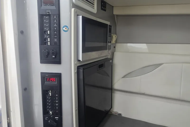  Yacht Photos Pics 2016 Extreme Boats interior with microwave, control panel, and seating area.
