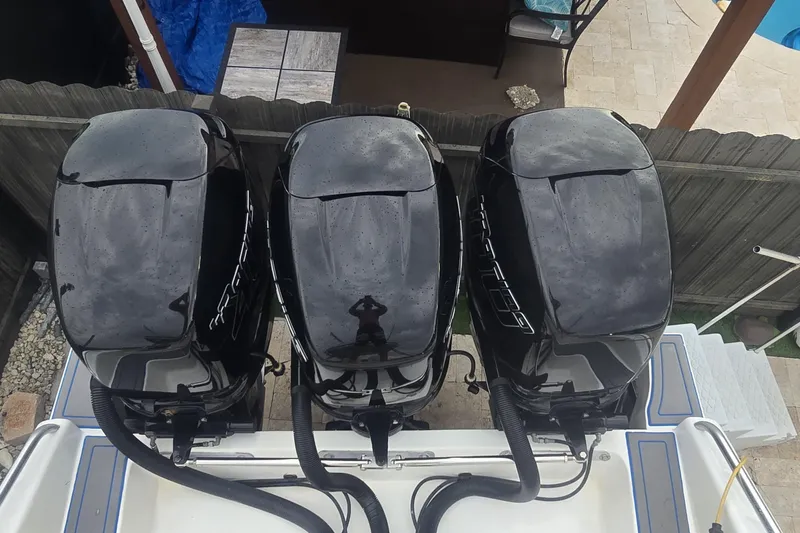  Yacht Photos Pics Three powerful outboard motors on a 2016 Extreme Boats vessel, viewed from above.