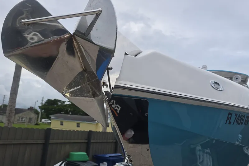  Yacht Photos Pics 2016 Extreme Boats model with a shiny anchor and blue hull, docked outdoors.