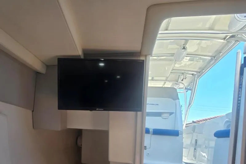  Yacht Photos Pics Interior view of a 2016 Extreme Boats model featuring a mounted TV and open deck.