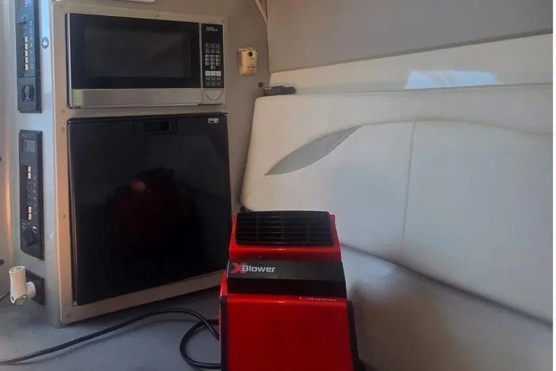  Yacht Photos Pics Interior of a 2016 Extreme Boats model with microwave, fridge, and red blower.