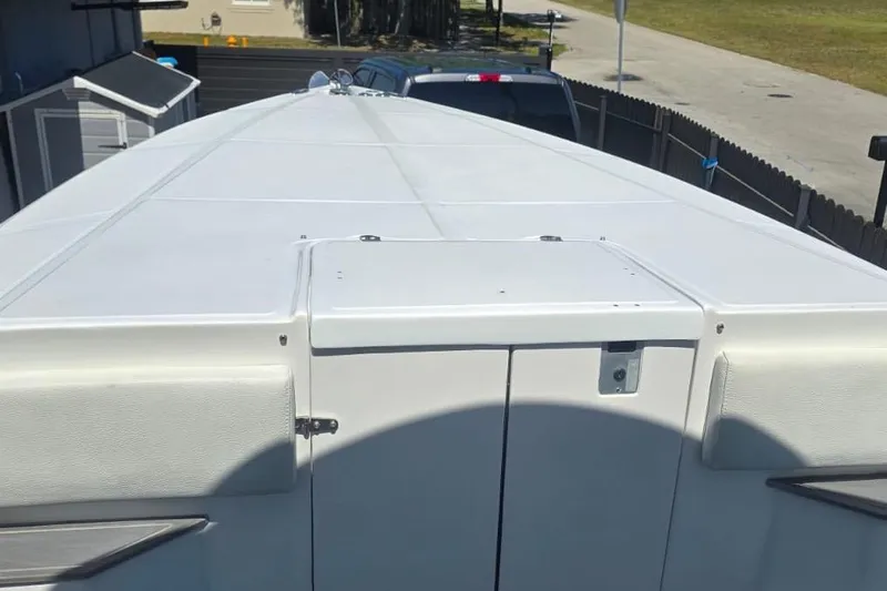  Yacht Photos Pics 2016 Extreme Boats model, white deck view, parked near a fence and driveway.