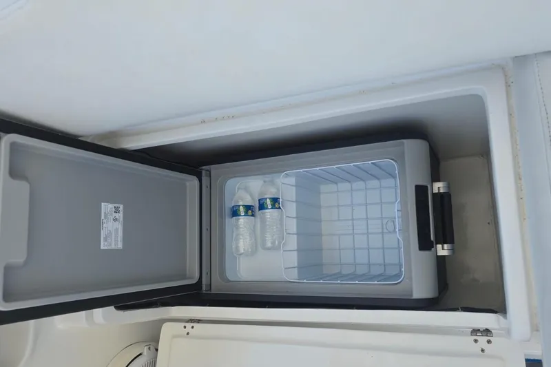  Yacht Photos Pics Built-in cooler on 2016 Extreme Boats, containing two water bottles.