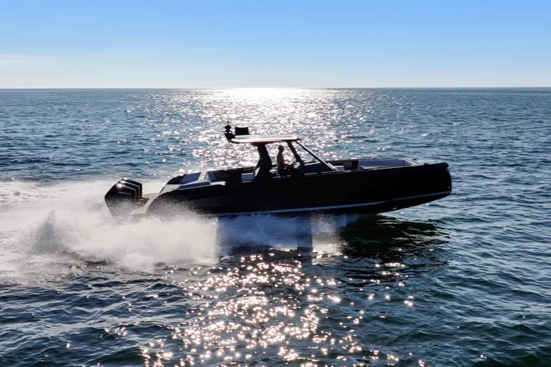 Liberty Yacht Photos Pics 2024 Vanquish Yachts VQ40 cruising on open water under a clear blue sky.