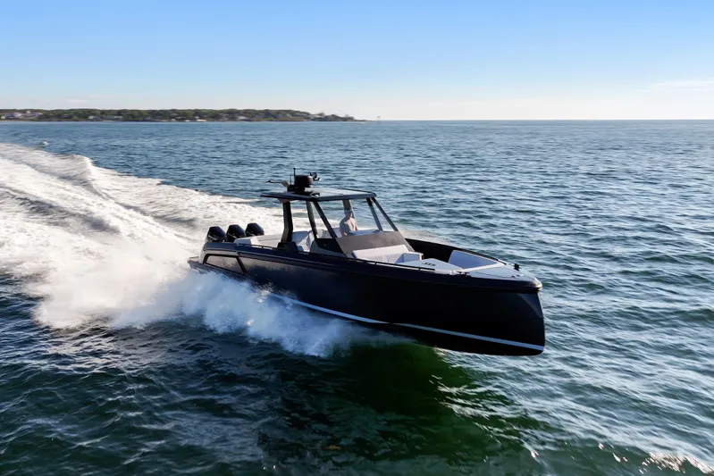 Liberty Yacht Photos Pics 2024 Vanquish Yachts VQ40 cruising on open water under clear blue skies.