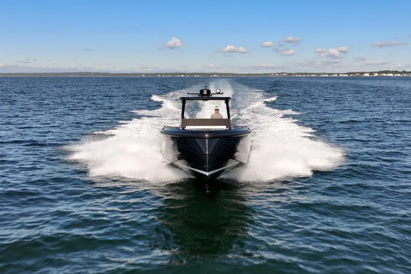Liberty Yacht Photos Pics 2024 Vanquish Yachts VQ40 cruising on open water under a clear blue sky.