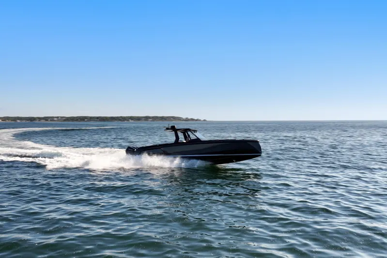 Liberty Yacht Photos Pics 2024 Vanquish Yachts VQ40 cruising on open water under clear blue sky.