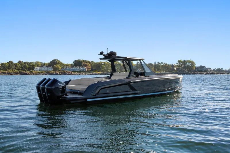 Liberty Yacht Photos Pics 2024 Vanquish Yachts VQ40 luxury boat on serene water with scenic background.
