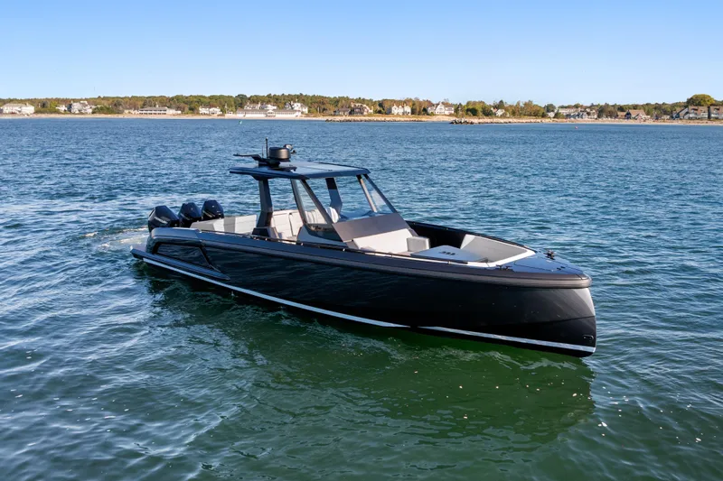 Liberty Yacht Photos Pics 2024 Vanquish Yachts VQ40 luxury boat cruising on a serene lake.