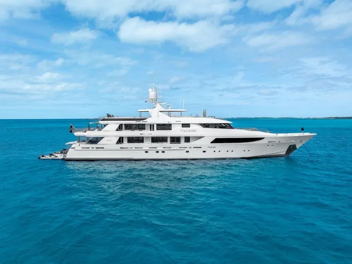 Valinor Yacht Photos Pics Luxurious 2013 Westport W164 yacht cruising on clear blue ocean waters.