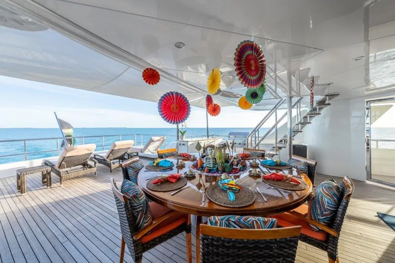 Valinor Yacht Photos Pics Luxurious 2013 Westport W164 yacht deck with festive dining setup and ocean view.