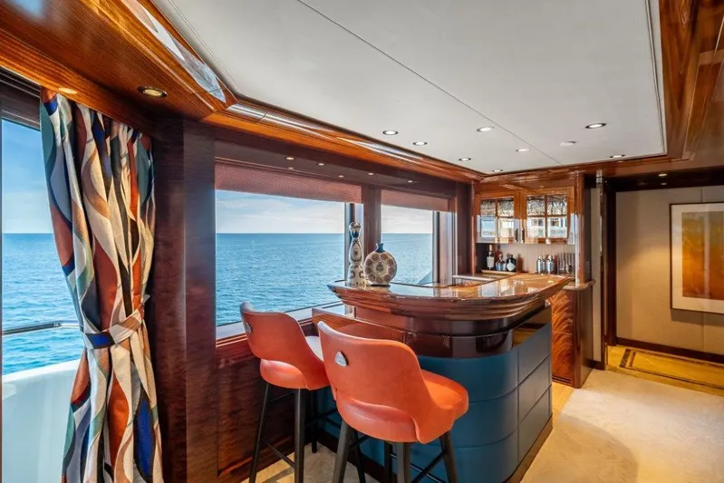 Valinor Yacht Photos Pics Luxurious yacht interior with ocean view, featuring a stylish bar and vibrant decor.