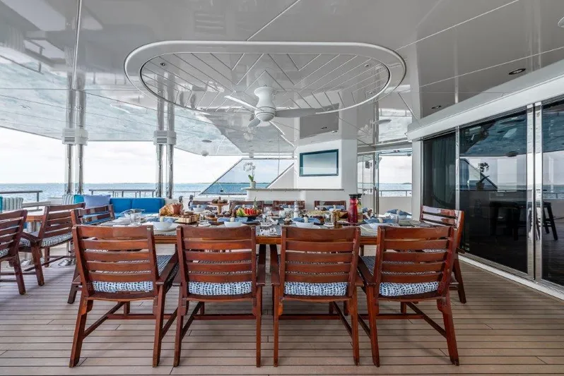 Valinor Yacht Photos Pics Luxurious dining area on 2013 Westport W164 yacht with elegant wooden chairs and ocean view.
