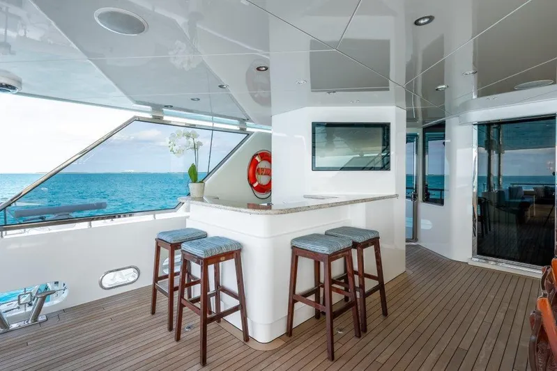 Valinor Yacht Photos Pics Luxurious 2013 Westport W164 yacht deck with bar stools and ocean view.