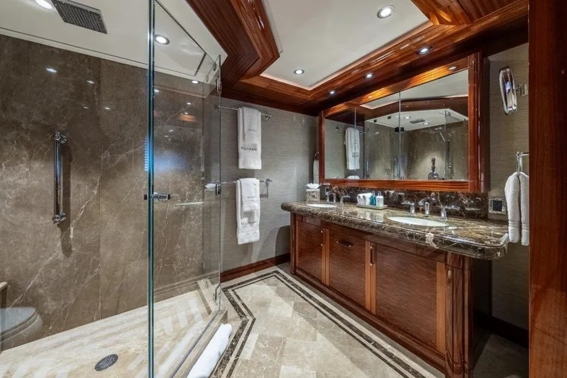 Valinor Yacht Photos Pics Luxurious bathroom in 2013 Westport W164 yacht with marble and wood finishes.