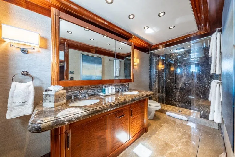 Valinor Yacht Photos Pics Luxurious yacht bathroom with marble countertops, wooden cabinetry, and glass shower in Westport W164, 2013.