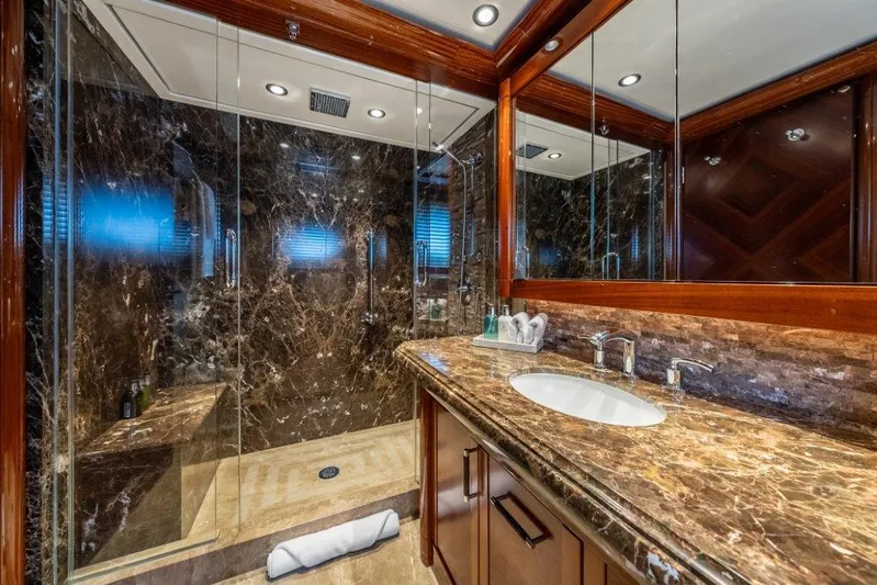 Valinor Yacht Photos Pics Luxurious marble bathroom in 2013 Westport W164 yacht with glass shower enclosure.