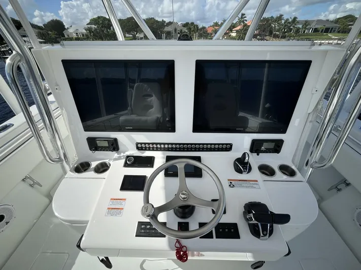  Yacht Photos Pics Contender 44ST 2021 boat helm with dual screens and steering wheel.