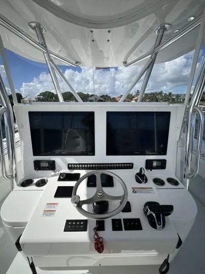  Yacht Photos Pics 2021 Contender 44ST boat helm with dual screens and steering wheel.