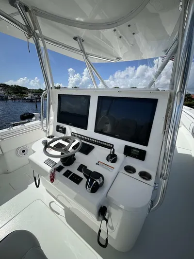  Yacht Photos Pics 2021 Contender 44ST boat helm with dual screens and steering wheel.