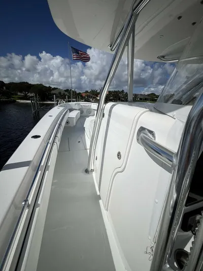  Yacht Photos Pics 2021 Contender 44ST boat deck with American flag, sleek design, and stainless steel railings.