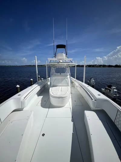  Yacht Photos Pics 2021 Contender 44ST boat on calm water under clear blue sky.