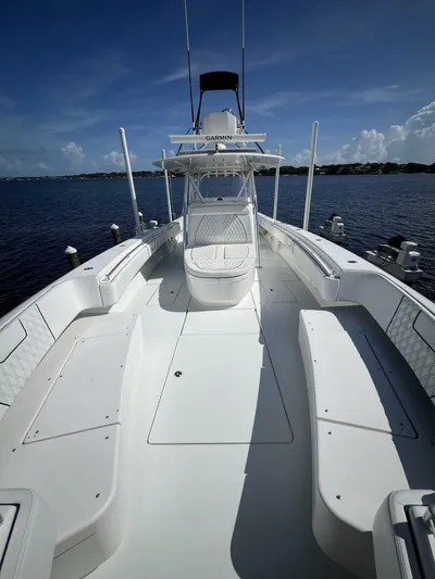  Yacht Photos Pics 2021 Contender 44ST boat with spacious deck, docked on a sunny day.