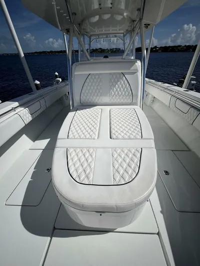  Yacht Photos Pics 2021 Contender 44ST boat interior with white quilted seating on open water.