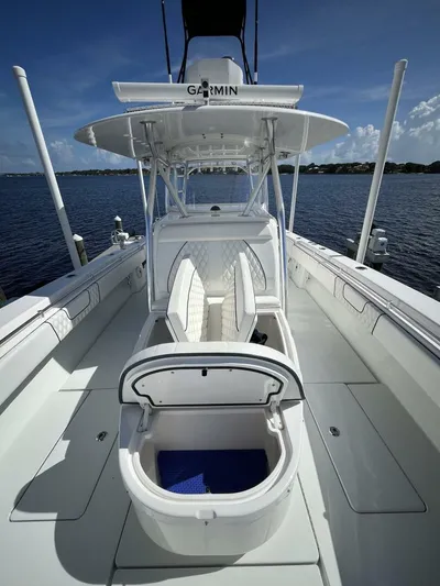  Yacht Photos Pics 2021 Contender 44ST boat with open deck and Garmin equipment, docked by the water.