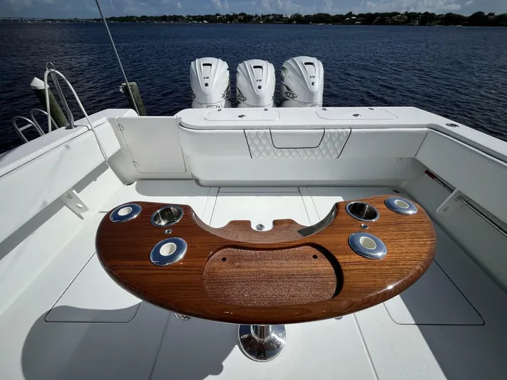  Yacht Photos Pics 2021 Contender 44ST boat with triple outboard engines and wooden fishing station.