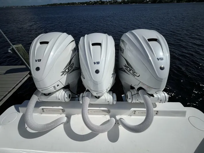  Yacht Photos Pics 2021 Contender 44ST boat with triple Yamaha V8 outboard engines on a calm lake.