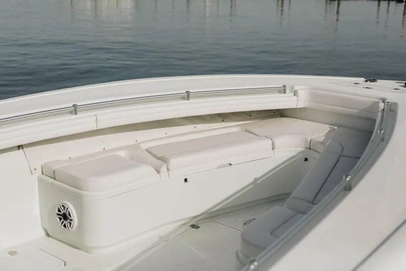 Lunasea Yacht Photos Pics 2023 Yellowfin 32 Offshore boat interior with cushioned seating and stainless steel railings.