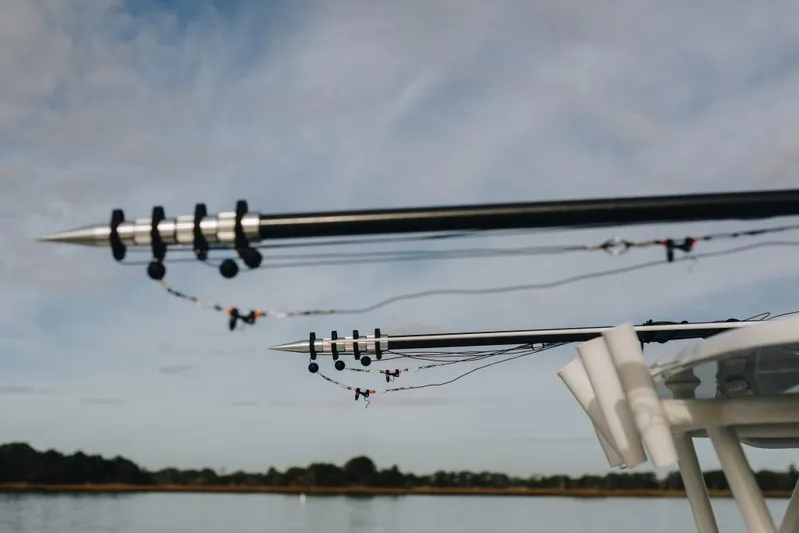 Lunasea Yacht Photos Pics Outriggers on a 2023 Yellowfin 32 Offshore boat against a cloudy sky.