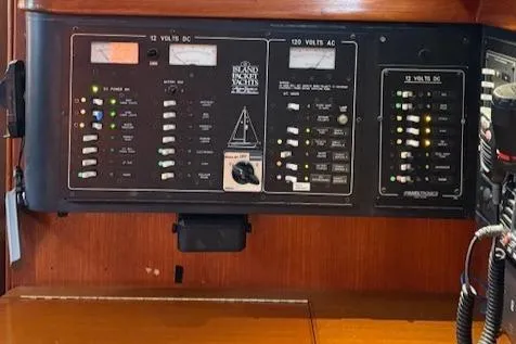Windragon Yacht Photos Pics Control panel of a 1995 Island Packet 37 sailboat, featuring various switches and gauges.