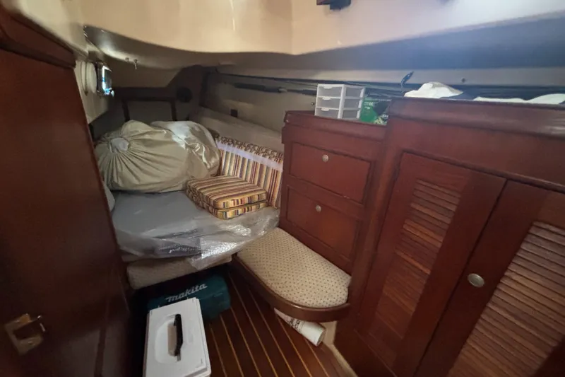 Windragon Yacht Photos Pics Cozy cabin interior of a 1995 Island Packet 37 sailboat with wooden furnishings.