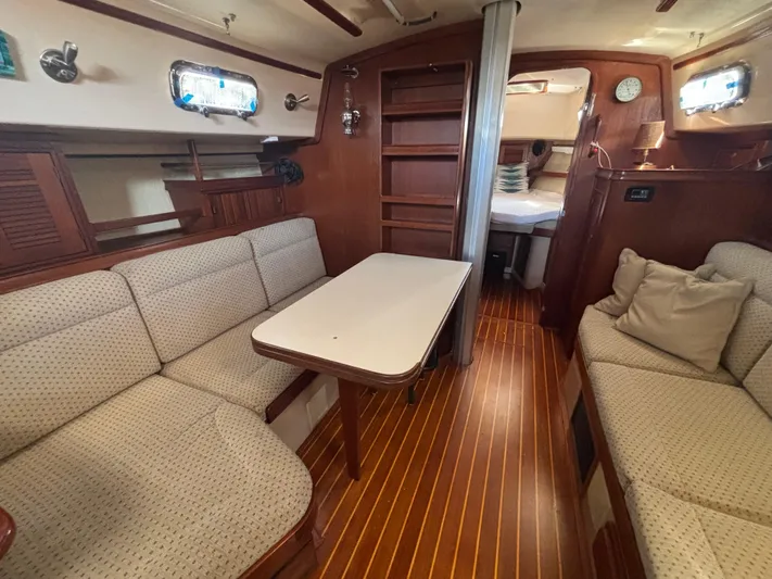 Windragon Yacht Photos Pics Interior of 1995 Island Packet 37 sailboat with cozy seating and wooden finishes.