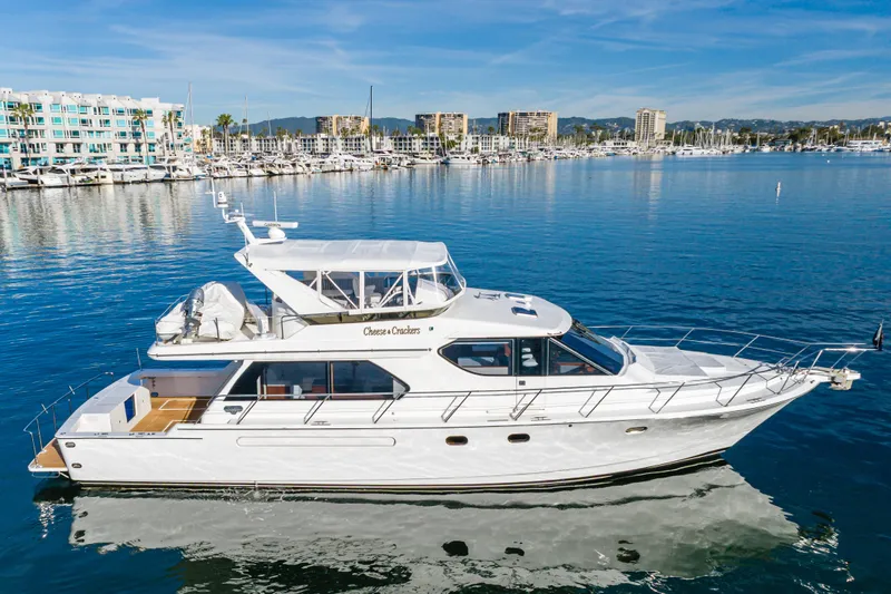  Yacht Photos Pics Luxury 2006 West Bay 64 yacht docked in a scenic marina setting.