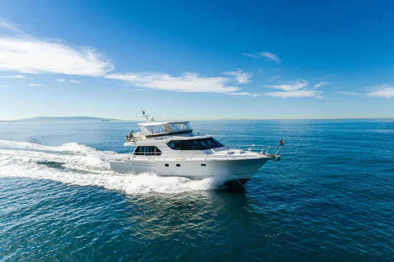  Yacht Photos Pics Luxurious 2006 West Bay 64 yacht cruising on open blue sea under clear skies.