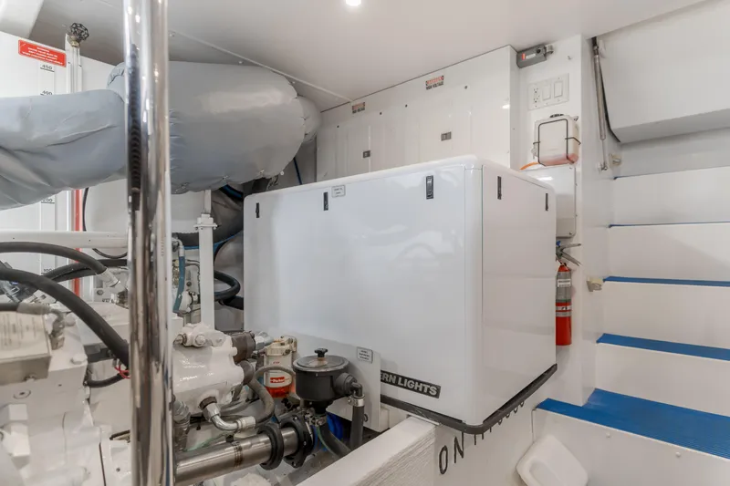  Yacht Photos Pics Engine room of 2006 West Bay 64 yacht with generator and equipment.