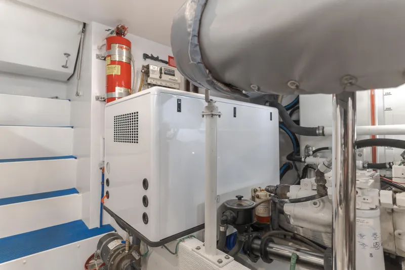  Yacht Photos Pics Engine room of 2006 West Bay 64 yacht with equipment and fire extinguisher.