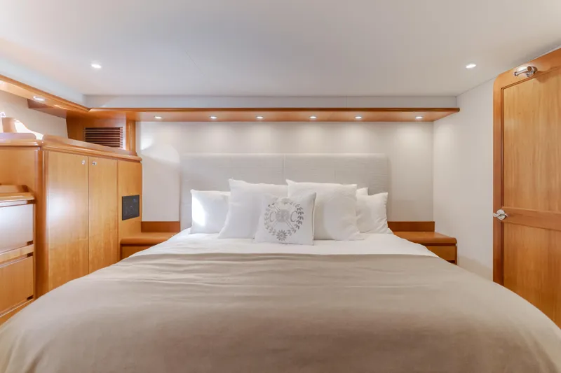  Yacht Photos Pics Luxurious bedroom interior of 2006 West Bay 64 yacht with elegant wood finishes.