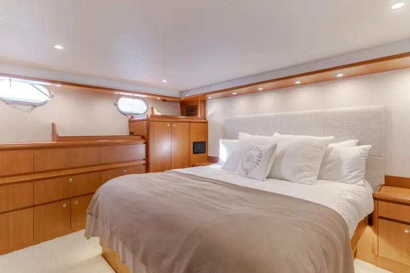 Yacht Photos Pics Luxurious bedroom interior of 2006 West Bay 64 yacht with elegant wood finishes.
