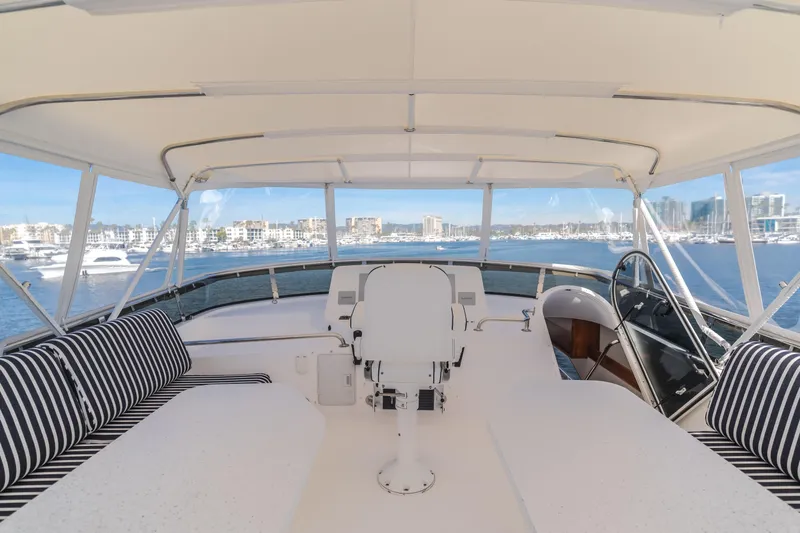  Yacht Photos Pics Luxurious 2006 West Bay 64 yacht interior with striped seating and panoramic marina view.