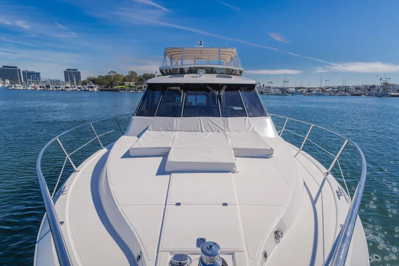  Yacht Photos Pics 2006 West Bay 64 yacht on calm water with marina backdrop.