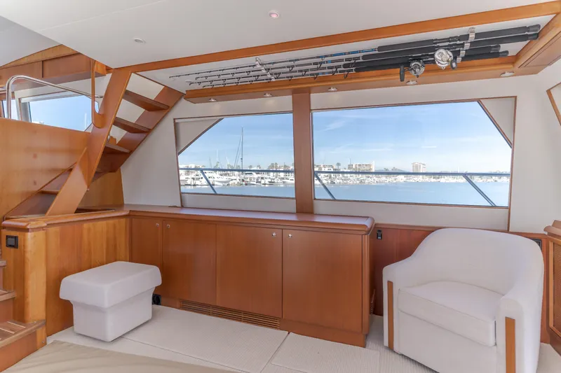  Yacht Photos Pics Luxurious interior of 2006 West Bay 64 yacht with wooden cabinetry and marina view.