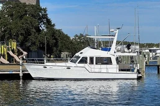  Yacht Photos Pics 2007 Island Pilot 395 yacht docked at marina, surrounded by trees and playground.